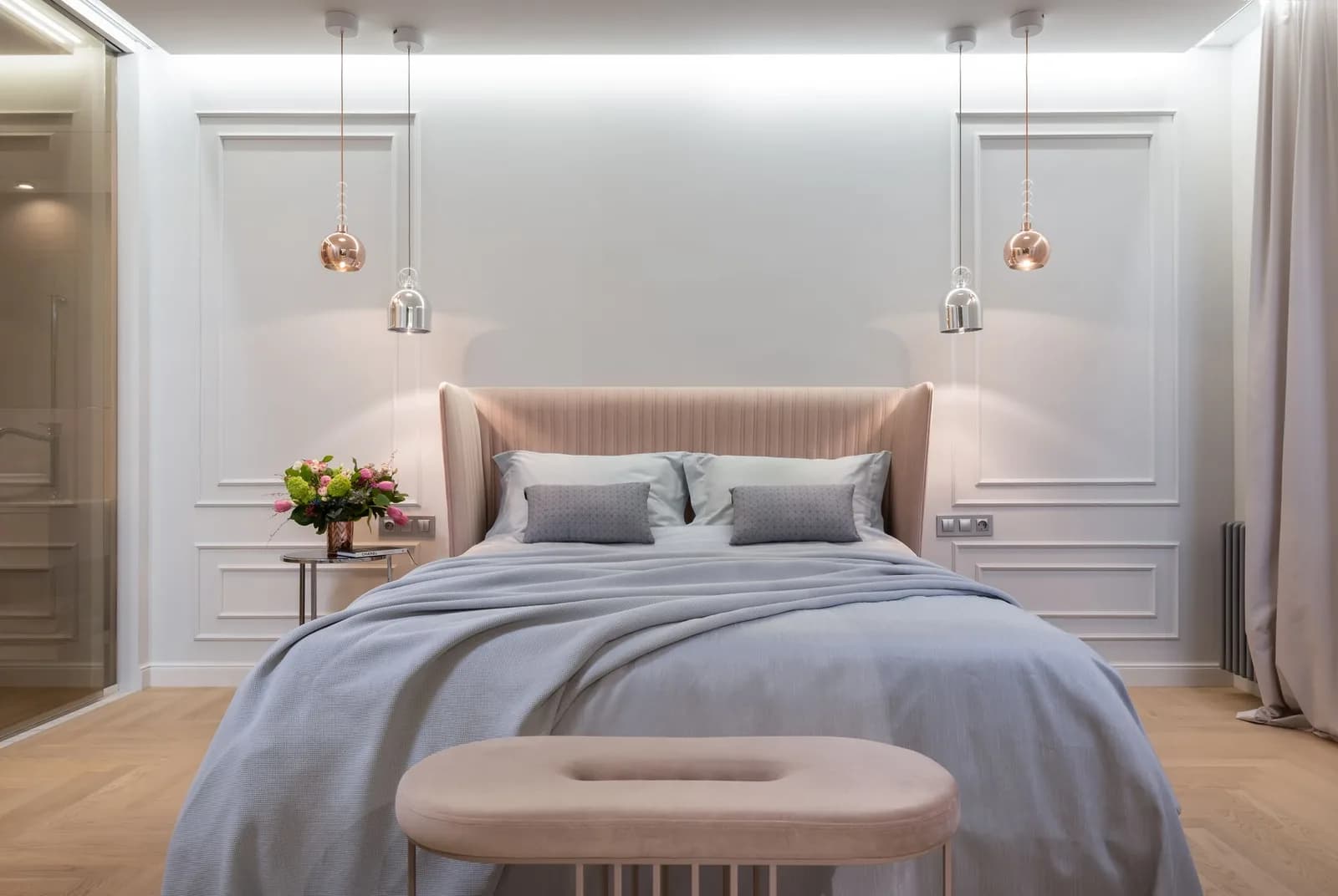 A welcoming modern bedroom with soft ambient lighting and clean bedding