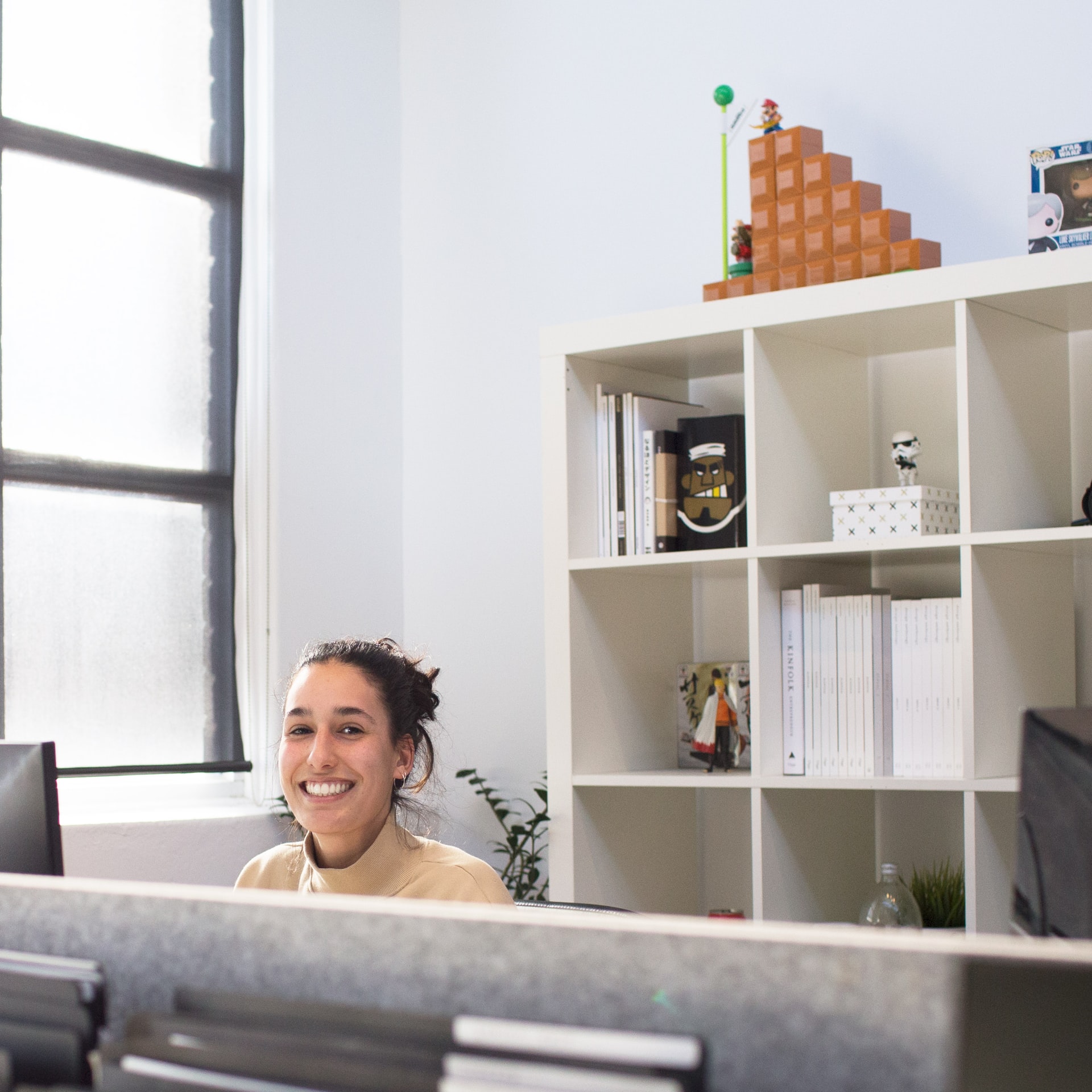 Woman, smiling, sitting in an office